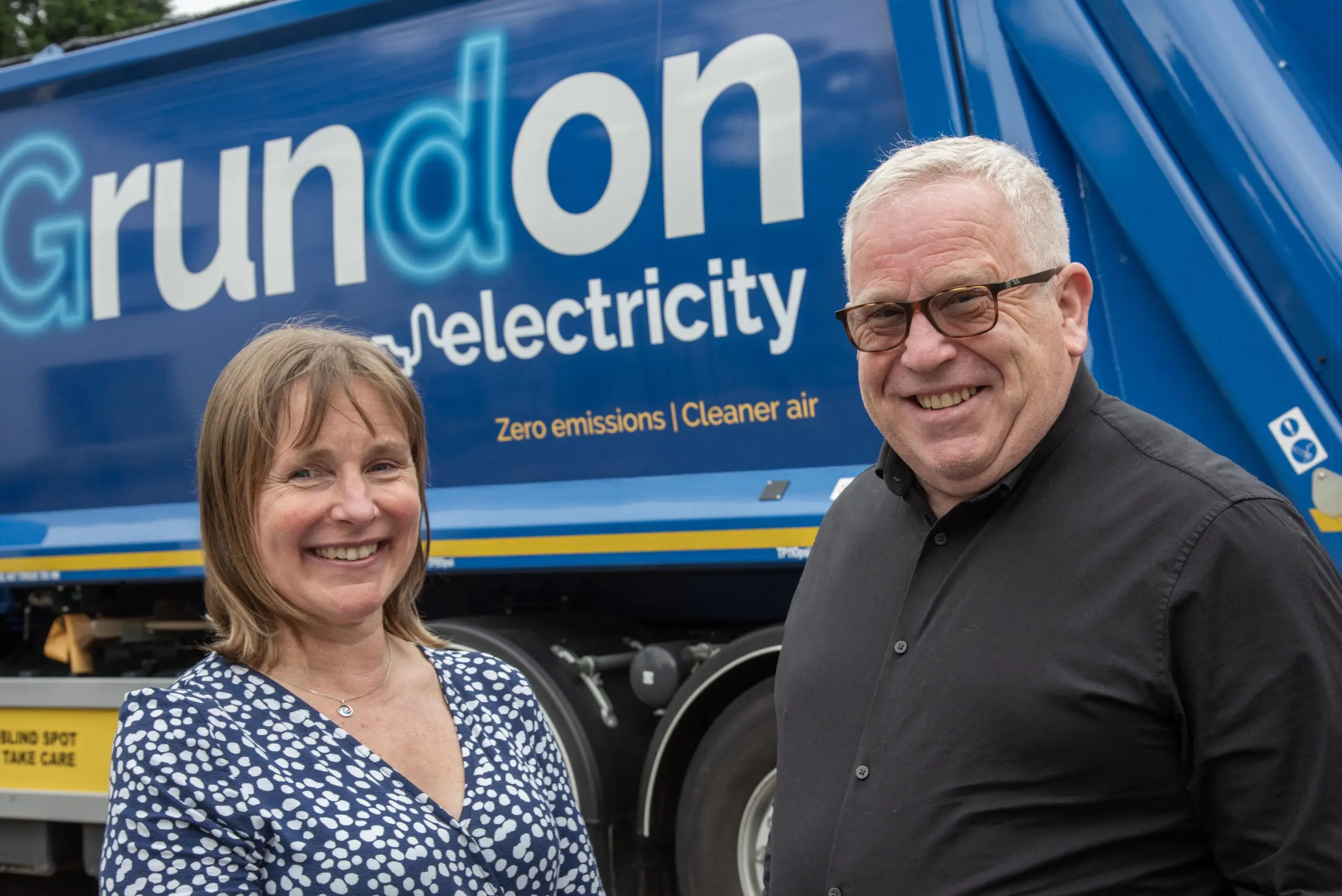 Grundon’s Becky Lillywhite is pictured with Liam Hogg in front of one of Grundon’s electric waste collection vehicles.