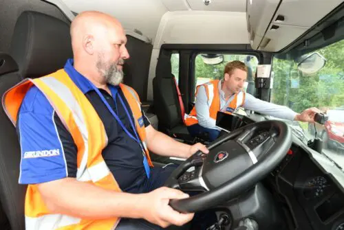 Pictured right Chris Double briefs Jason Warrick, a Grundon driver, on the new AI-led dash cams
