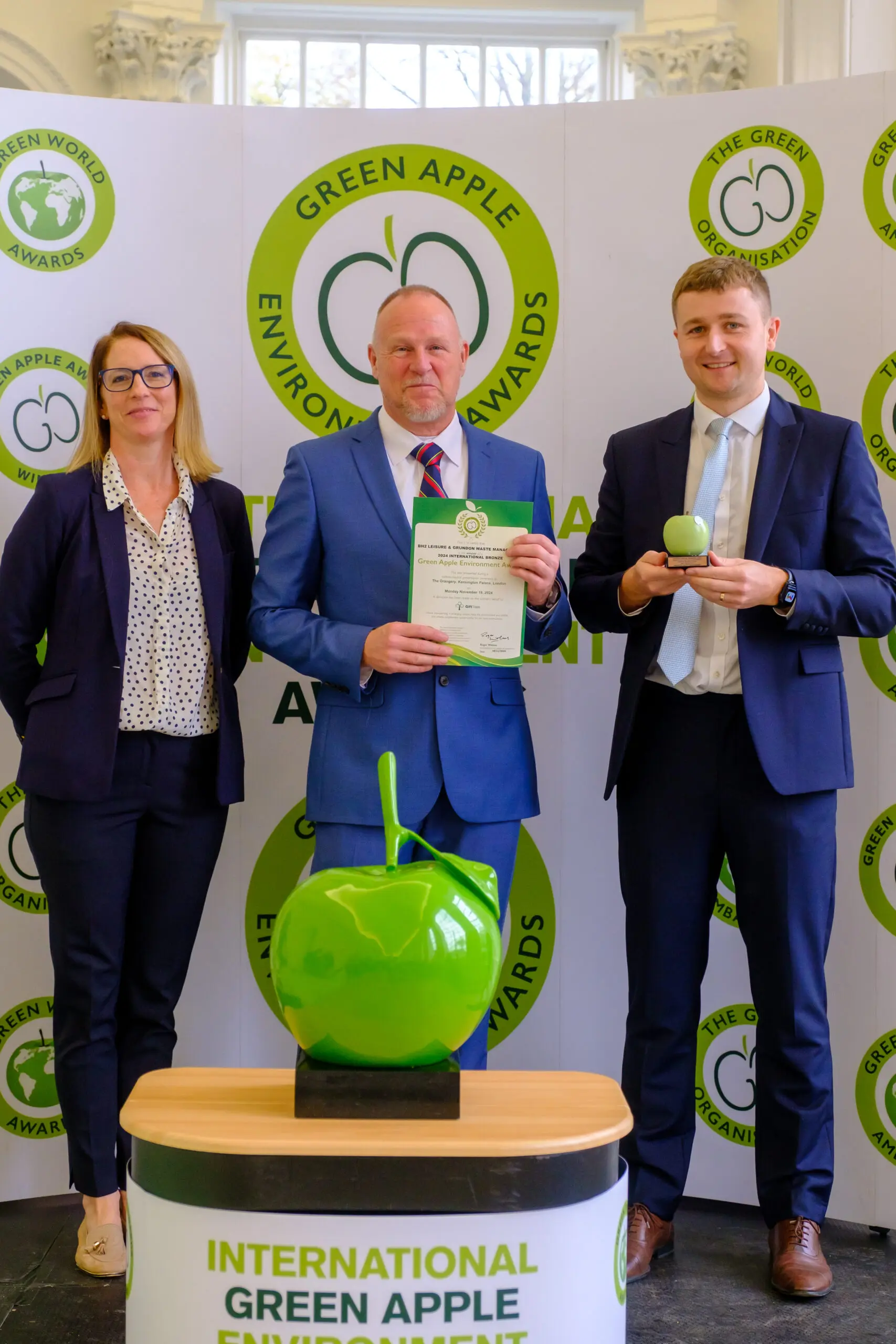 Bh2 Leisure's Bryan Taylor, centre, is pictured with Grundon's James Luckett as they receive the award from Helen Kitchen